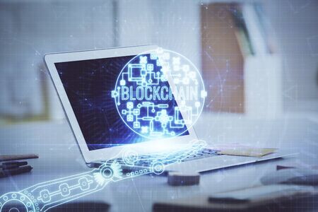 Multi exposure of blockchain theme hologram and table with computer background. Concept of bitcoin crypto currency.の写真素材