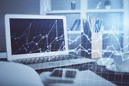 Double exposure of graph and financial info and work space with computer background. Concept of international online trading.の写真素材