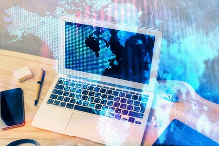 Multi exposure of chart and financial info and work space with computer background. Concept of international online trading.の写真素材