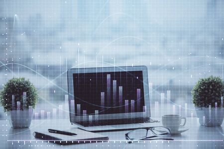 Stock market graph and table with computer background. Double exposure. Concept of financial...