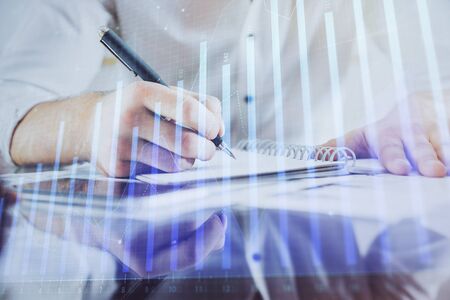 Multi exposure of man planing investment with stock market forex chart background. Concept of research and trading.の写真素材