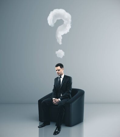 Businessman sitting in chair with drawing question mark over head. Business problem conceptの写真素材