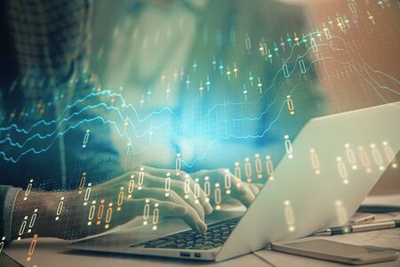 Double exposure of stock market chart with man working on computer on background. Concept of...