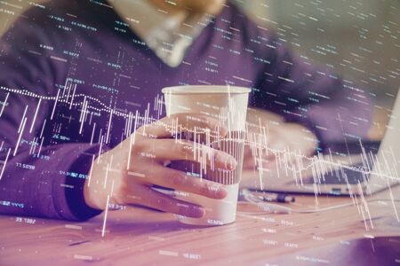 Forex graph with businessman working on computer in office on background. Concept of hardworking....