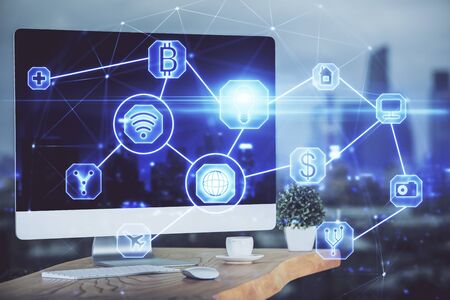 Computer on desktop with social network theme icon. Multi exposure. Concept of international connections.の写真素材