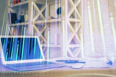 Financial market graph hologram and personal computer on background. Double exposure. Concept of forex.の写真素材