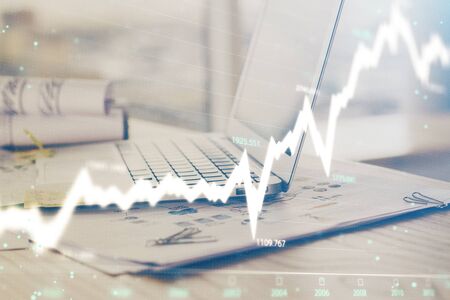 Forex Chart hologram on table with computer background. Multi exposure. Concept of financial...