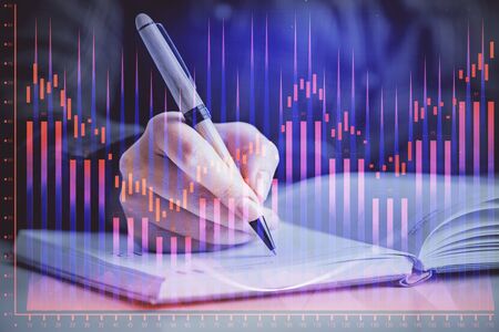 Double exposure of womans hands making notes with forex graph hologram. Concept technical analysis.の写真素材