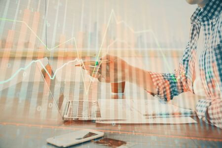 Multi exposure of stock market chart with man working on computer on background. Concept of financial analysis.の写真素材