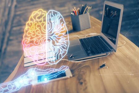 Double exposure of table with computer and brain hologram. Data innovation concept.の写真素材