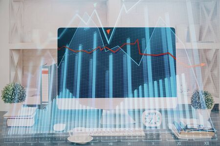 Forex graph hologram on table with computer background. Double exposure. Concept of financial markets.の写真素材