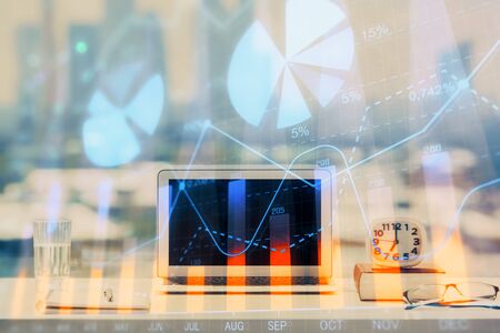 Forex Chart hologram on table with computer background. Multi exposure. Concept of financial...