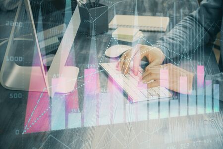 Double exposure of financial graph with man works in office on background. Concept of analysis.の写真素材