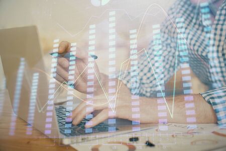 Multi exposure of forex graph with man working on computer on background. Concept of market analysis.の写真素材