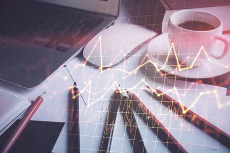 Double exposure of chart and financial info and work space with computer background. Concept of international online trading.の写真素材