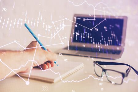 Multi exposure of man hands with stock market forex graph.の写真素材