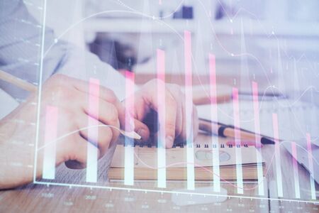 Multi exposure closeup hands with stock market forex graph.の写真素材
