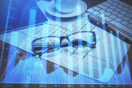 Financial chart hologram with glasses on the table background. Concept of business. Double exposure.の写真素材