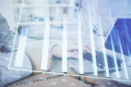Multi exposure of stock market chart with man working on computer on background. Concept of financial analysis.の写真素材