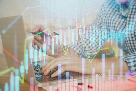 Multi exposure of forex graph with man working on computer on background. Concept of market analysis.の写真素材