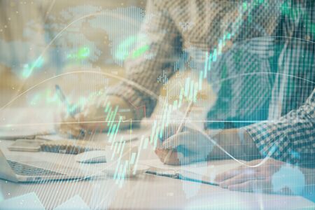 Multi exposure of forex chart with man working on computer on background. Concept of market...