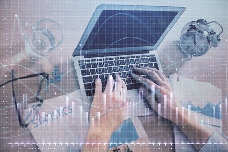 Multi exposure of forex graph with man working on computer on background. Concept of market...