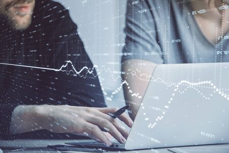 Forex graph with businessman typing on computer in office on background. Concept of analysis. Double exposure.の写真素材