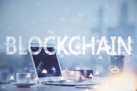Multi exposure of blockchain theme hologram and table with computer background. Concept of bitcoin crypto currency.の写真素材