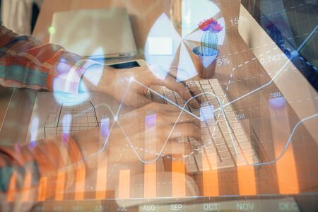 Double exposure of stock market chart with man working on computer on background. Concept of...