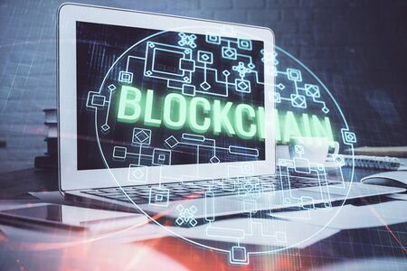 Multi exposure of blockchain theme hologram and table with computer background. Concept of bitcoin...