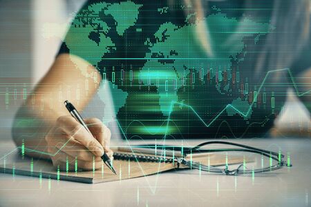 Multi exposure of womans hands making notes with forex graph hologram. Concept of technical...