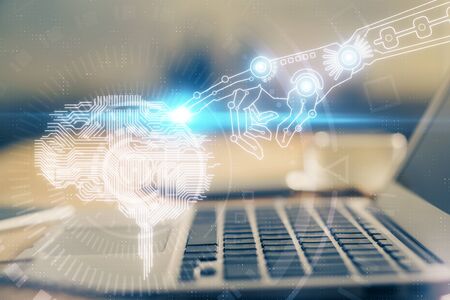 Double exposure of table with computer and brain hologram. Data innovation concept.