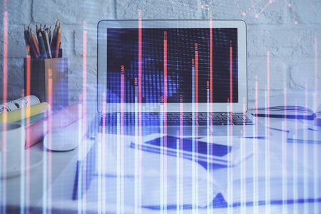 Stock market graph and table with computer background. Double exposure. Concept of financial analysis.の写真素材