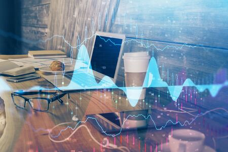 Double exposure of forex chart and work space with computer. Concept of international online trading.の写真素材