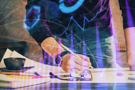 Double exposure of man writing on paper with forex graph.