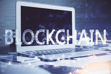 Multi exposure of blockchain theme hologram and table with computer background. Concept of bitcoin crypto currency.の写真素材