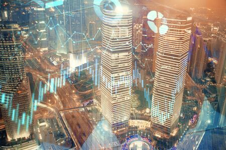 Financial chart on city scape with tall buildings background multi exposure. Analysis concept.の写真素材