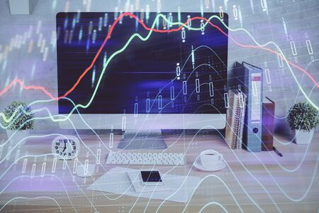 Forex graph hologram on table with computer background. Double exposure. Concept of financial...