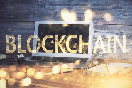 Multi exposure of blockchain theme hologram and table with computer background. Concept of bitcoin crypto currency.の写真素材