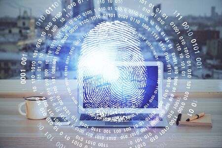 Computer on desktop in office with finger print drawing. Double exposure. Concept of business data security.の写真素材