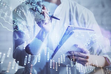 Financial chart drawn over hands taking notes background. Concept of research. Multi exposure
