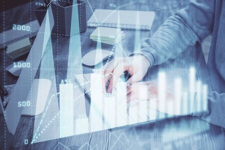 Double exposure of financial graph with man works in office on background. Concept of analysis.の写真素材