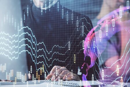 Forex graph with businessman typing on computer in office on background. Concept of analysis. Double...