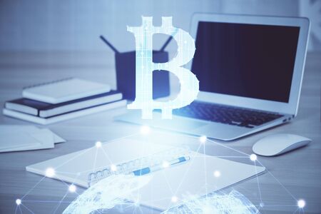 Multi exposure of blockchain theme hologram and table with computer background. Concept of bitcoin...