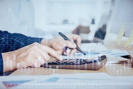 Financial trading graph double exposure with man desktop background.