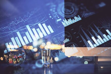 Financial chart drawing and table with computer on background. Double exposure. Concept of...