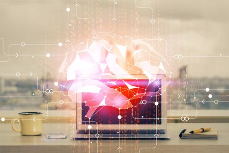Double exposure of table with computer and brain hologram. Data innovation concept.