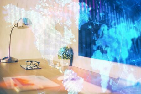 Stock market graph on background with desk and personal computer. Multi exposure. Concept of financial analysis.の写真素材