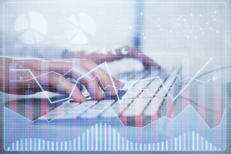 Forex graph with businessman working on computer in office on background. Concept of hardworking....