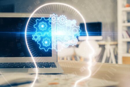 Double exposure of table with computer and brain hologram. Data innovation concept.